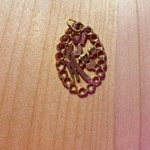 Pendant that says Maman on it.